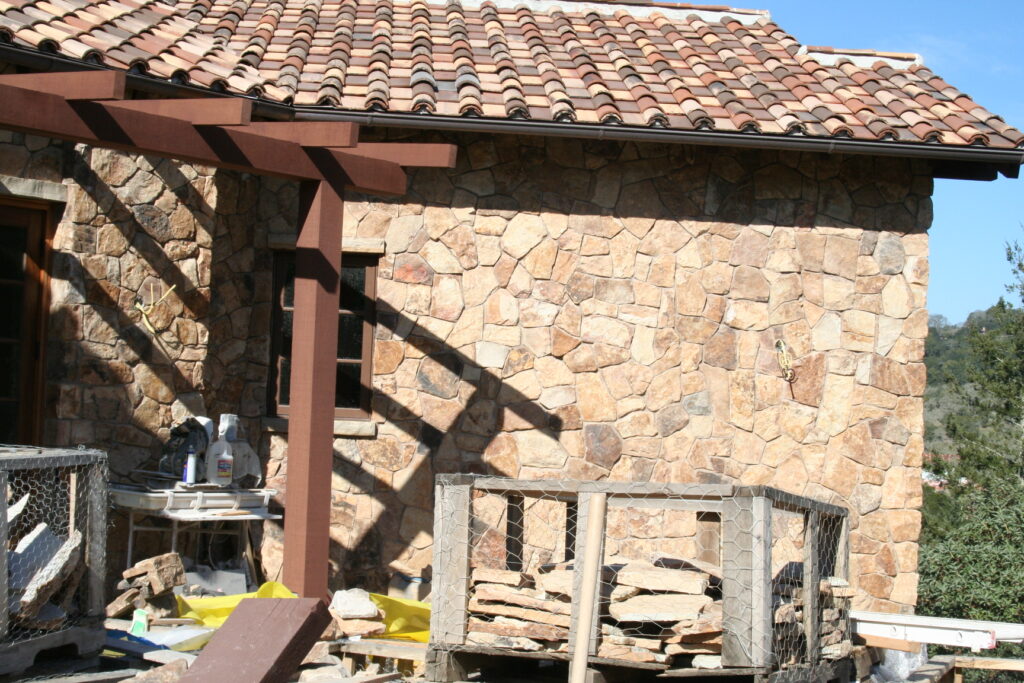 exterior of a building features seamless cut stone veneer that matches the garden planters just outside the building