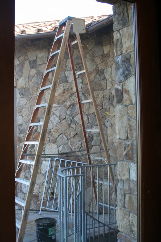 a ladder leads up from the second story balcony to the roof for contractors to use
