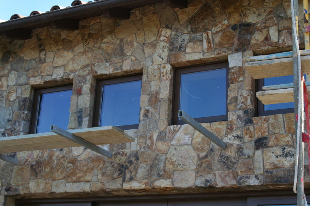 exterior of a building features seamless cut stone veneer that matches the garden planters just outside the building