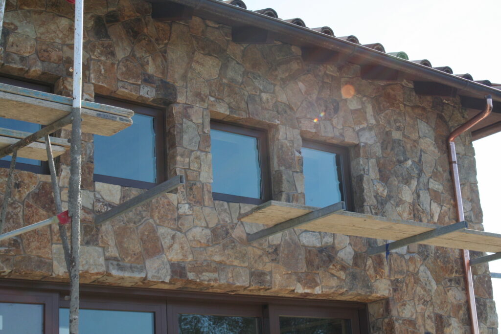 exterior of a building features seamless cut stone veneer that matches the garden planters just outside the building