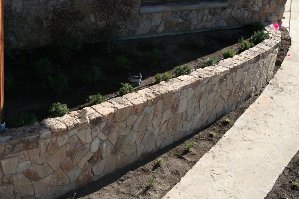 exterior of a building features seamless cut stone veneer that matches the garden planters just outside the building