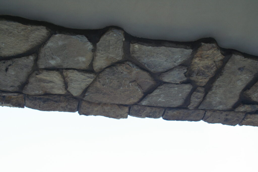 closeup of the stone veneer that wraps under the second story balcony