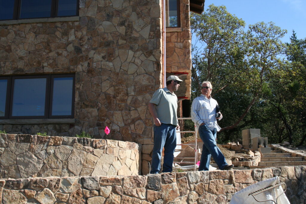 Conrad and his client stand on one of the garden tiers overlooking the recently completed masonry project