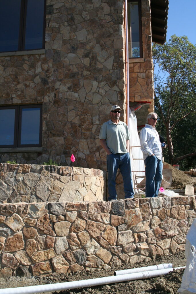 Conrad and his client stand on one of the garden tiers overlooking the recently completed masonry project