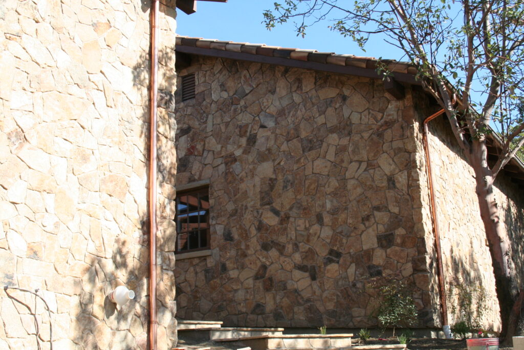 the team at Masonry by Conrad works on the cut stone veneer for a Santa Rosa estate high up in the hills