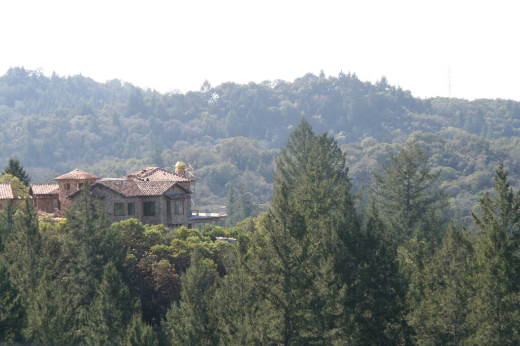 the team at Masonry by Conrad works on the cut stone veneer for a Santa Rosa estate high up in the hills; the estate is surrounded by native trees like redwoods