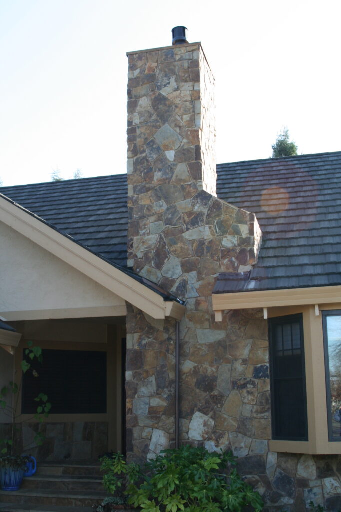 cut stone veneer chimney viewed from the outside of a Santa Rosa residence