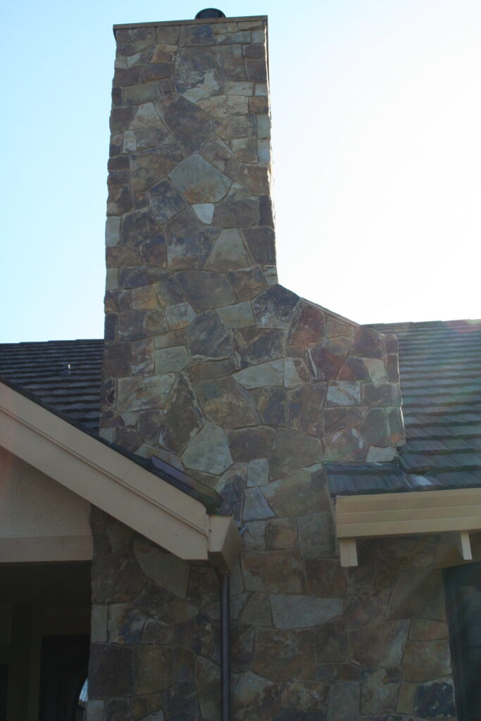 cut stone veneer chimney viewed from the outside of a Santa Rosa residence