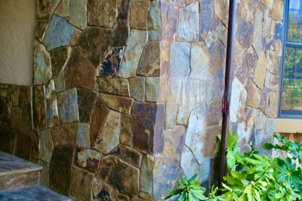 cut stone skirting blends into the front landing with steps of a Santa Rosa residence