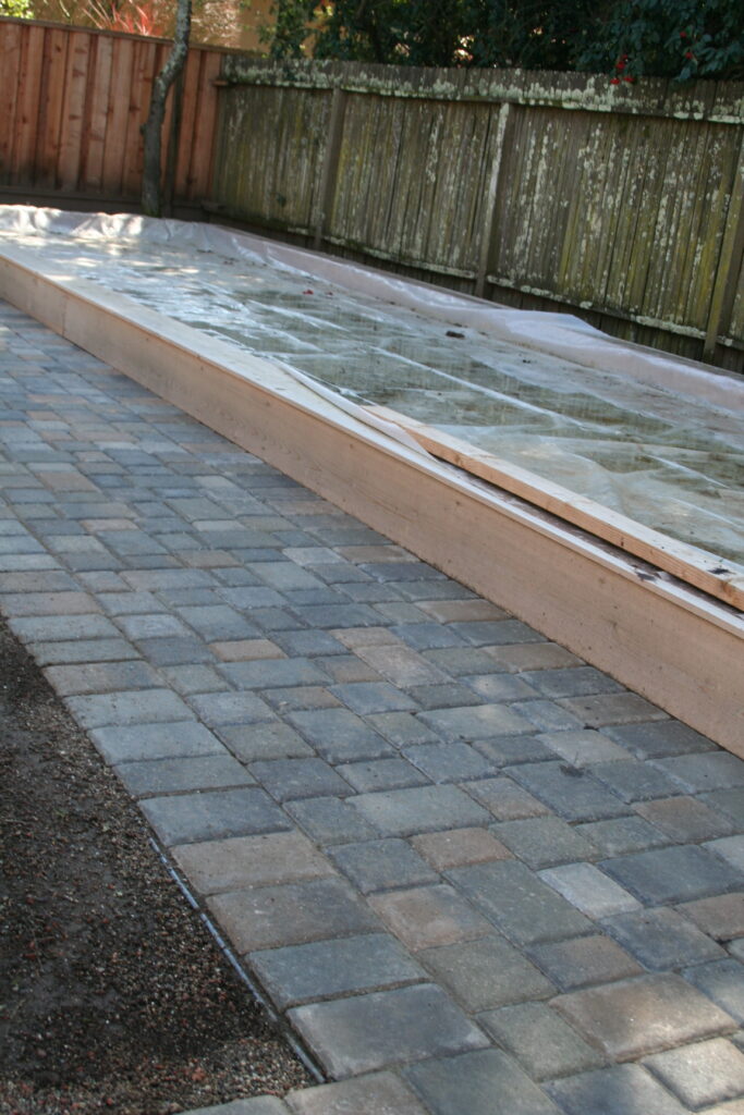 patio pavers surrounding a wooden planter