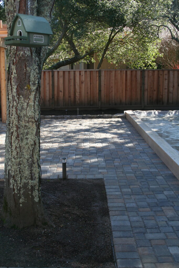 patio pavers surrounding a wooden planter