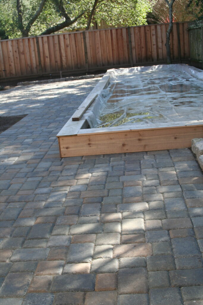 patio pavers surrounding a wooden planter