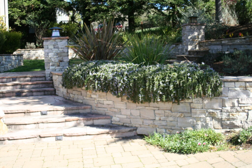 cut stone treads and steps leading up the side of a residence into the surrounding front yard