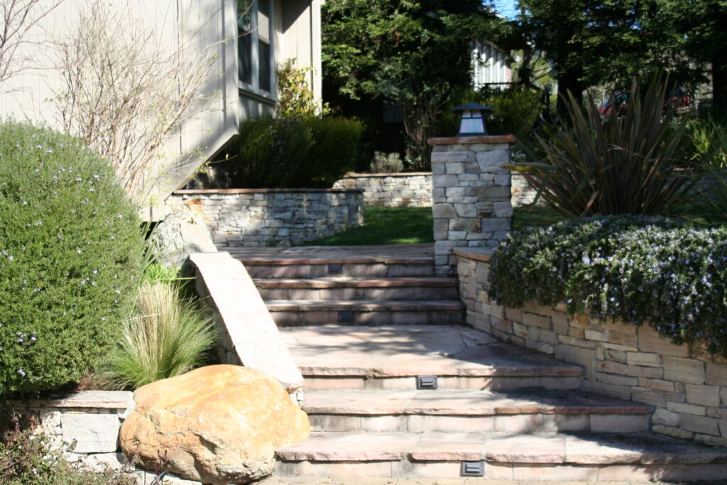 cut stone treads and steps leading up the side of a residence into the surrounding front yard