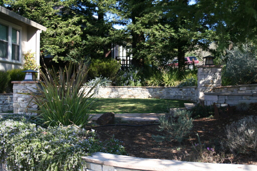 cut stone veneer retaining wall for a tiered front yard landscape