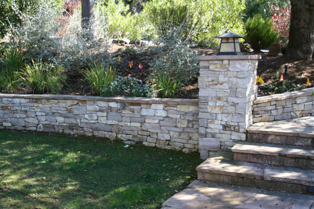 cut stone veneer retaining wall for a tiered front yard landscape