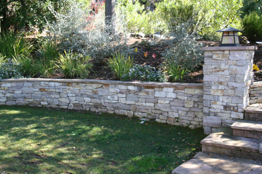cut stone veneer retaining wall for a tiered front yard landscape