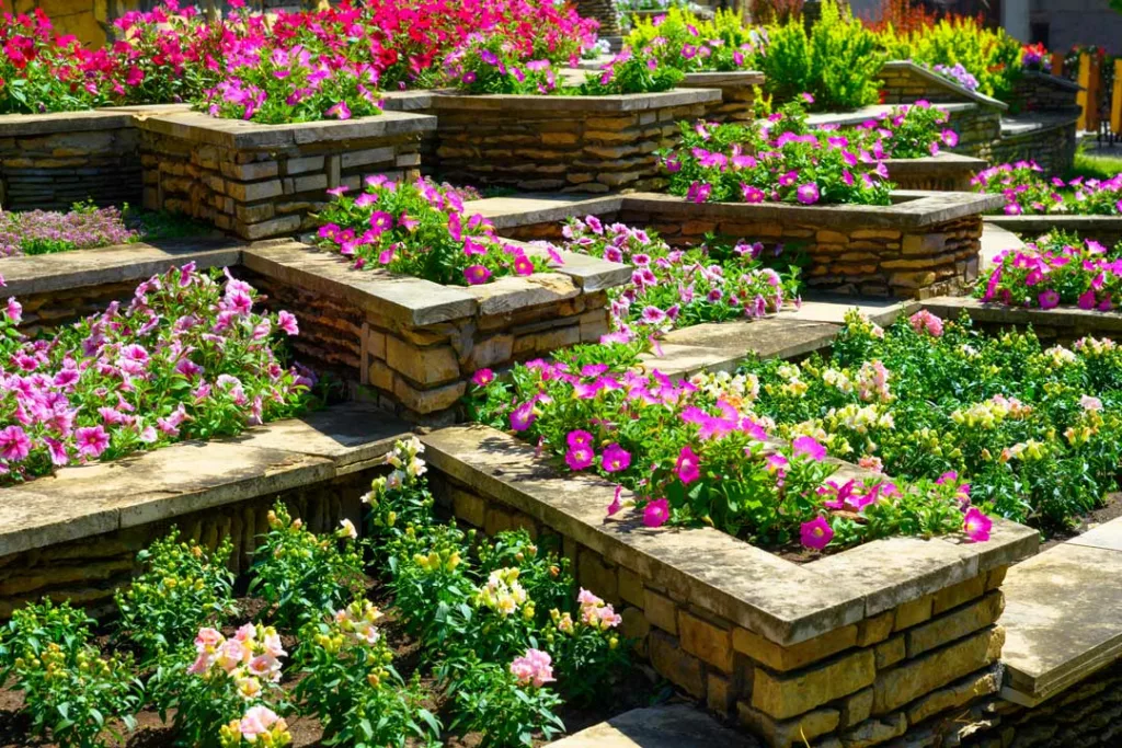 cut stone tiered planters filled with blooming flowers