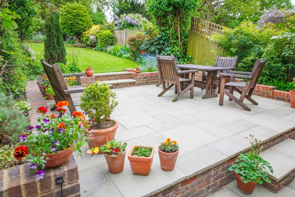 stone and brick patio overlooking a perfectly manicured garden