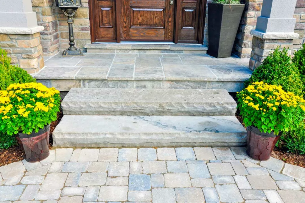 wide stone steps lead up to a heavy wooden door